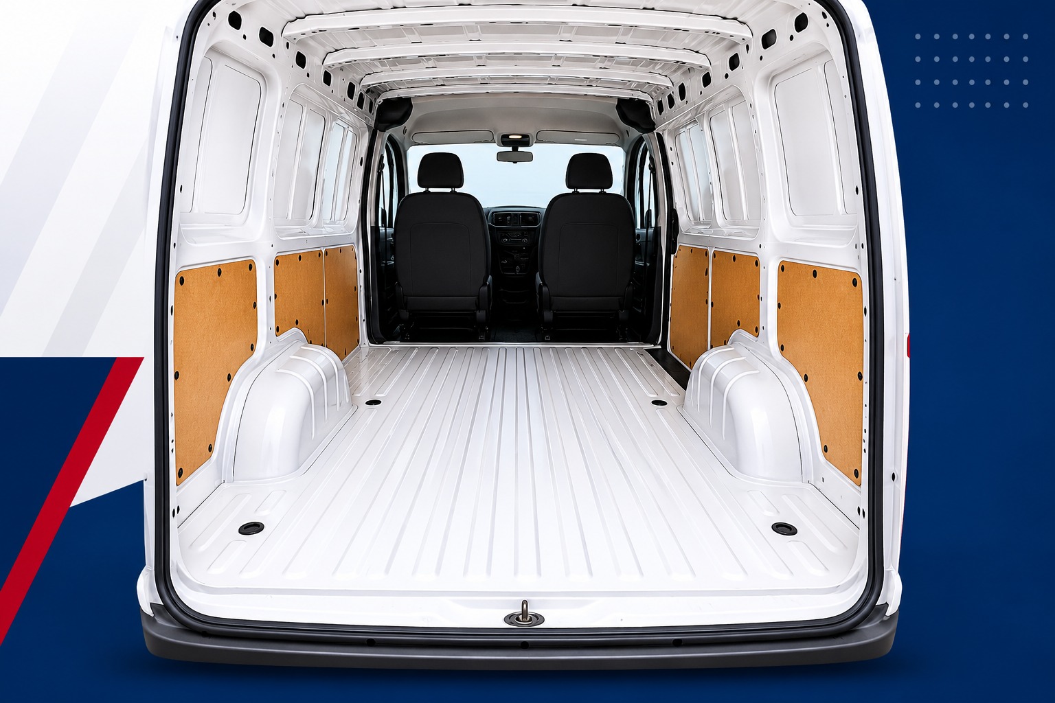 An empty van cargo area looking from the rear doors toward the front, showing the flat floor space between the rear tires.